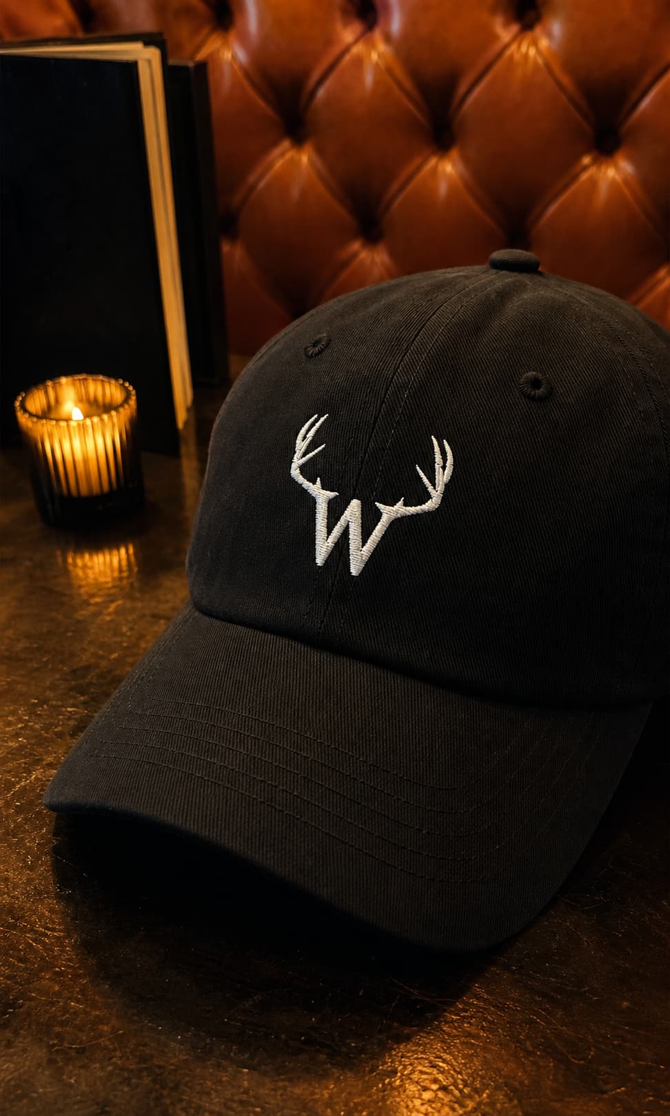 The Horn Dad Cap embroidery beside a candlelit leather booth